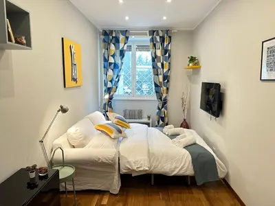 a small bedroom with a bed and a chair at Botticelli 2 Guesthouse in Rome
