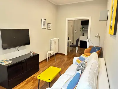 a living room with a white couch and a flat screen tv at Botticelli 2 Guesthouse in Rome