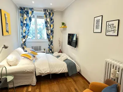 a small bedroom with a bed and a tv at Botticelli 2 Guesthouse in Rome