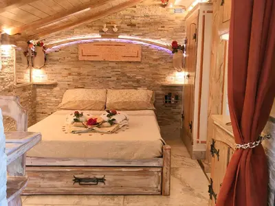 a bedroom with a bed with flowers on it at Domus Corneliæ - Romantico Attico Roman & Jacuzzi - Metro A Cornelia in Rome