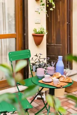 a green table with a plate of food on it at casa pinolo in Rome