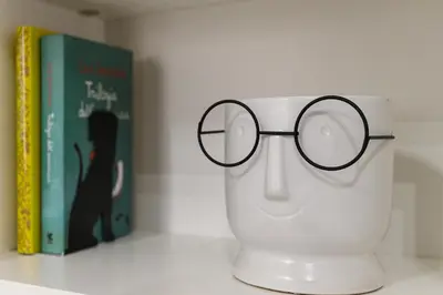 a pair of glasses sitting on top of a cup at Casa Ausilia in Rome