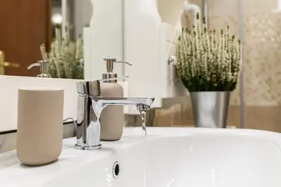 a bathroom sink with a faucet and a mirror at Casa Ausilia in Rome