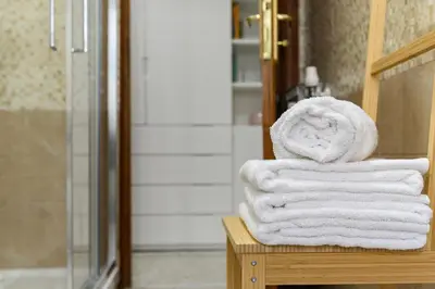 a stack of towels sitting on a table in a bathroom at Casa Ausilia in Rome