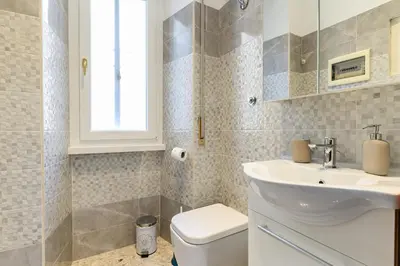 a bathroom with a white sink and a toilet at Casa Ausilia in Rome