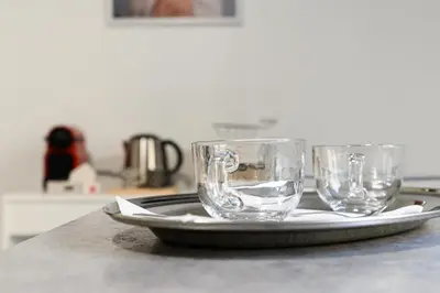 two empty glasses sitting on a plate on a table at Casa Ausilia in Rome