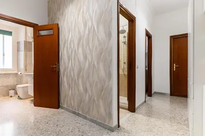 a bathroom with a glass door with a toilet at Casa Ausilia in Rome