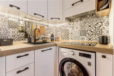 a kitchen with a washer and dryer at Sapienza Apt - Modern House in Piazza Bologna in Rome