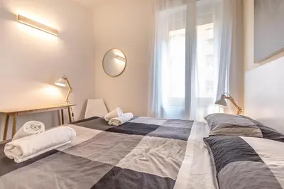 a bedroom with a large bed and a window at Sapienza Apt - Modern House in Piazza Bologna in Rome