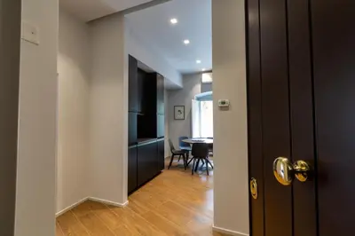 a hallway with a door and a dining room at Castroni Ottaviano Suite in Rome