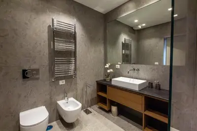 a bathroom with a sink and a toilet and a mirror at Castroni Ottaviano Suite in Rome