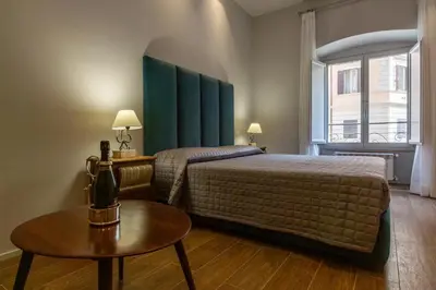 a hotel room with a bed and a table at Castroni Ottaviano Suite in Rome