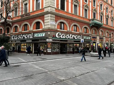 a large building with people walking in front of a store at Castroni Ottaviano Suite in Rome