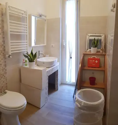 a bathroom with a sink and a toilet and a mirror at AugustoVera19 Tourist Accommodation in Rome