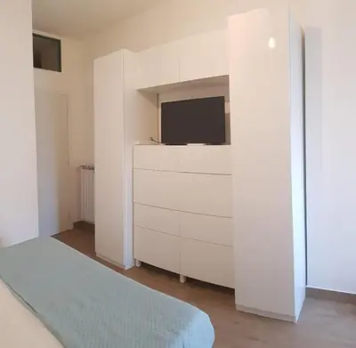 a living room with a tv and a white dresser at AugustoVera19 Tourist Accommodation in Rome