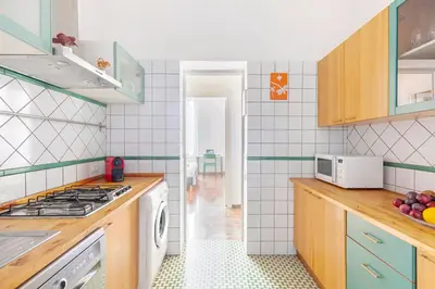 a kitchen with a sink and a stove top oven at Hostly-Maison Sant'Angelo-Few steps from Vatican in Rome