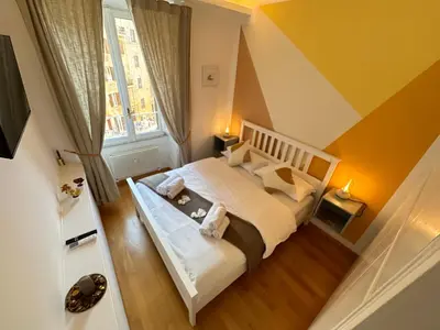 a bedroom with a white bed and a window at Angolo al Vignola in Rome