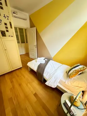 a bedroom with a bed and a striped wall at Angolo al Vignola in Rome