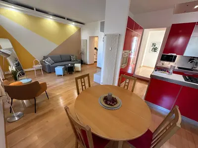 a kitchen and a living room with a table and chairs at Angolo al Vignola in Rome