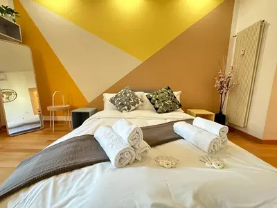 a large white bed with towels on top of it at Angolo al Vignola in Rome