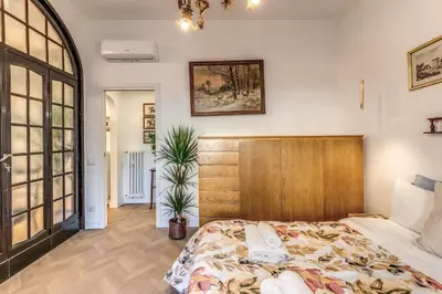 a bedroom with a bed with a wooden headboard at Belle Arti Home in Rome