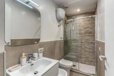 a bathroom with a sink and a toilet and a shower at Belle Arti Home in Rome