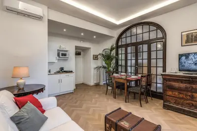 a living room with a white couch and a table at Belle Arti Home in Rome