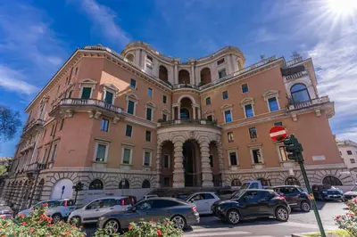 a large building with cars parked in front of it at Belle Arti Home in Rome