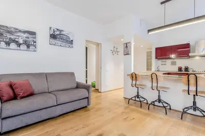 a living room with a couch and a kitchen at CasaTrastevere Alessio&Simone in Rome