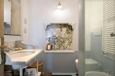 a bathroom with a sink and a toilet at Colosseo The Family Home in Monti in Rome