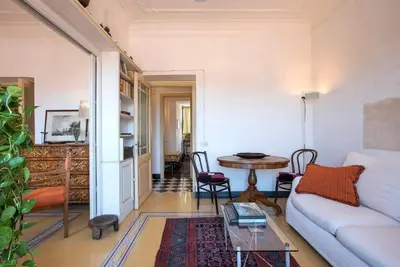 a living room with a couch and a table at Colosseo The Family Home in Monti in Rome