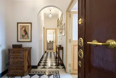 a hallway with a door and a tile floor at Colosseo The Family Home in Monti in Rome
