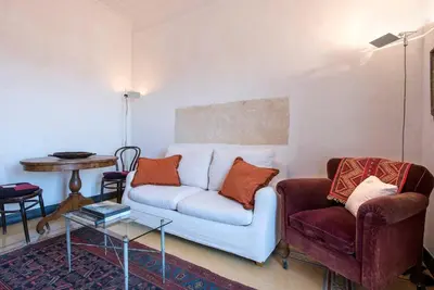a living room with a couch and two chairs at Colosseo The Family Home in Monti in Rome