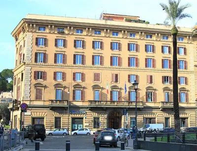a large building with cars parked in front of it at WE LOVE ROMA Guest House in Rome