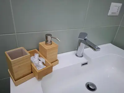 a bathroom sink with a soap dispenser and a faucet at Al posto di Luca in Rome