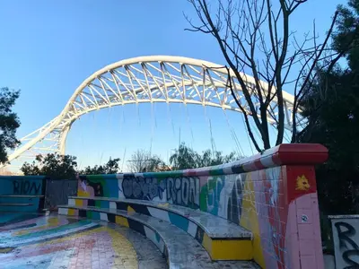 a roller coaster with a bridge in the background at Al posto di Luca in Rome