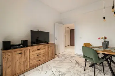 a living room with a television on a wooden dresser at Al posto di Luca in Rome