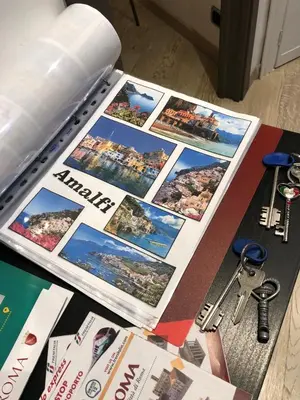 a table with a bunch of magazines and keys at The house of St. Peter in Rome