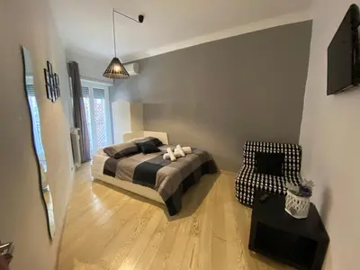 a bedroom with a bed and a chair in a room at The house of St. Peter in Rome