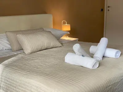 a bed with three rolled up towels on it at The house of St. Peter in Rome