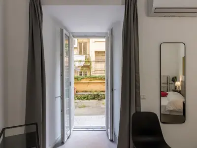 a hallway with a mirror and a bedroom with a bed at Apartment Welcome Rome by Interhome in Rome