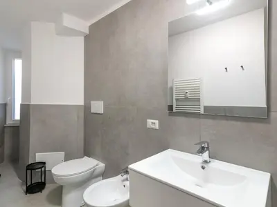 a bathroom with a sink and a toilet and a mirror at Apartment Welcome Rome by Interhome in Rome