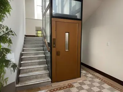 a stairway with a brown door and a staircase at Apartment Welcome Rome by Interhome in Rome