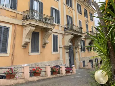 a building with flowerpots and balconies on a street at Apartment Welcome Rome by Interhome in Rome
