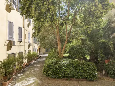 an alley with a tree in the middle of a building at Apartment Marsicum by Interhome in Rome