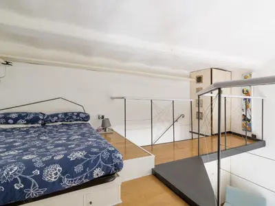 a bedroom with a bed and a staircase at Apartment Marsicum by Interhome in Rome