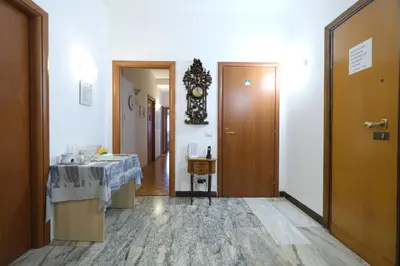 a bathroom with a sink and a clock on the wall at Guest House Piazza Tarquinia in Rome