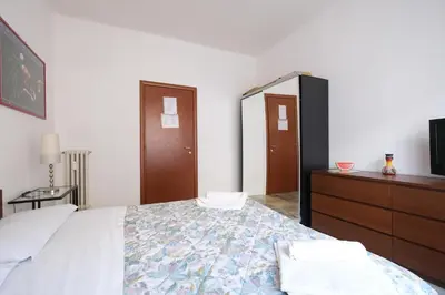 a bedroom with a bed and a dresser and a mirror at Guest House Piazza Tarquinia in Rome