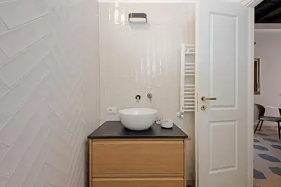 a bathroom with a white bowl sink on a counter at Trastevere Cisterna 4 in Rome