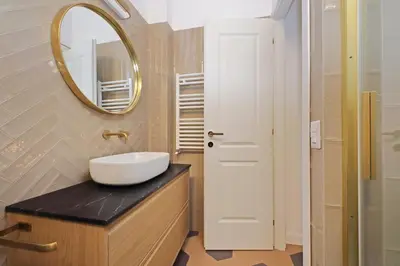 a bathroom with a sink and a mirror on a counter at Trastevere Cisterna 4 in Rome
